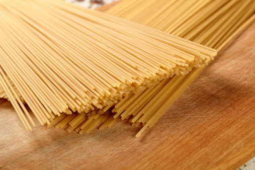Dry italian tagliatelle noodles pasta on kitchen countertop