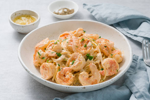 Pasta spaghetti with grilled shrimps bechamel sauce. Spaghetti with seafood rich cream. stock photo