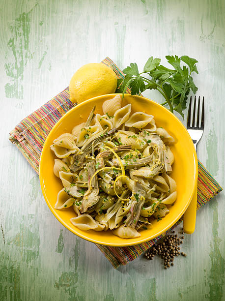 pasta with artichoke lemon peel and cilantro stock photo