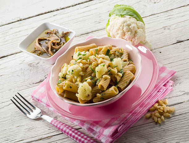 pasta with cauliflower anchovy and pine nuts stock photo