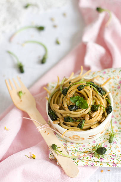 pasta with dandelion flower buds stock photo