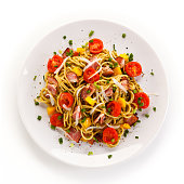 Pasta with meat, tomato sauce and vegetables on white background