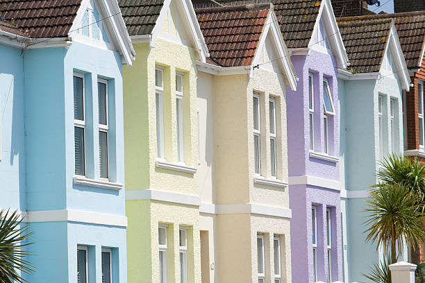 Pastel houses Line of soft-coloured homes in pretty Brighton street brighton stock pictures, royalty-free photos & images