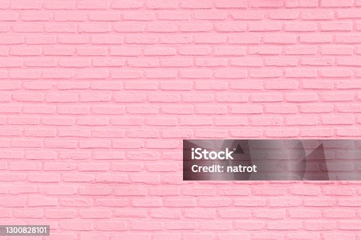 istock Pastel pink brick wall texture background 1300828101