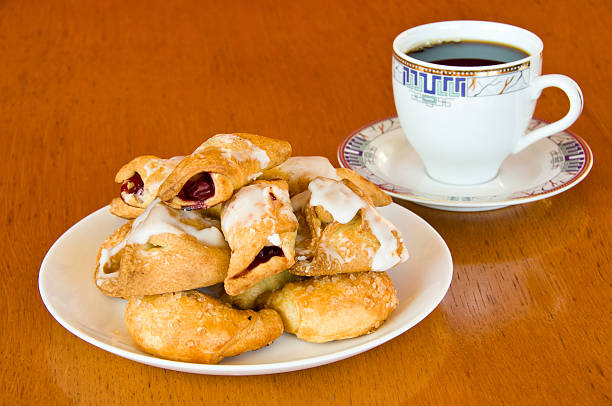 Pastry and a cup of coffee on wooden table stock photo