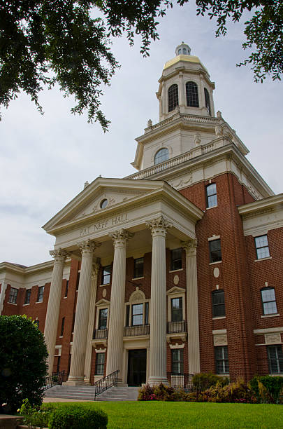Pat Neff Hall at Baylor University Pat Neff Hall is the administration building in the center of the campus at Baylor University.  Its bell tower is lit in the school's colors of green and gold at night and bells eminate from it on the quarter hour.  Baylor was founded in 1845, before Texas became a state. baylor basketball stock pictures, royalty-free photos & images