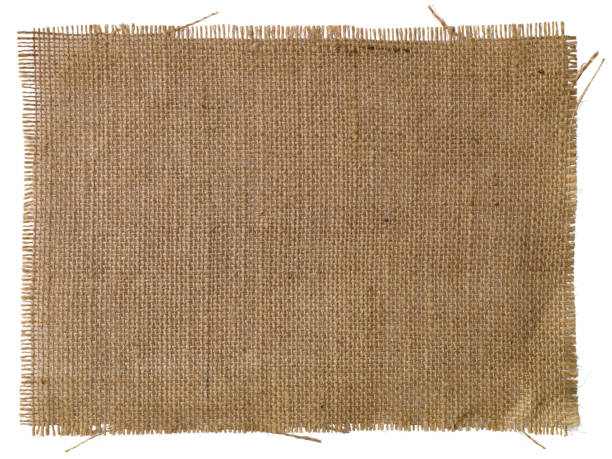 Patch of natural burlap fabric background. A patch of natural burlap fabric background, isolated on white, clipping path included. burlap stock pictures, royalty-free photos & images
