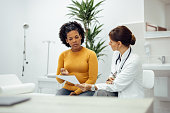 istock Patient and doctor discussing test results. 1343539369