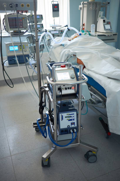 Patient in critical stance on a ventilator and ECMO pump due to RDS caused by virus pneumonia stock photo