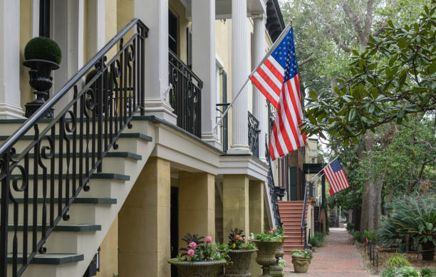 Patriotic Savannah, Georgia American flags hanging in one of the historic districts of Savannah, Georgia. historic district stock pictures, royalty-free photos & images