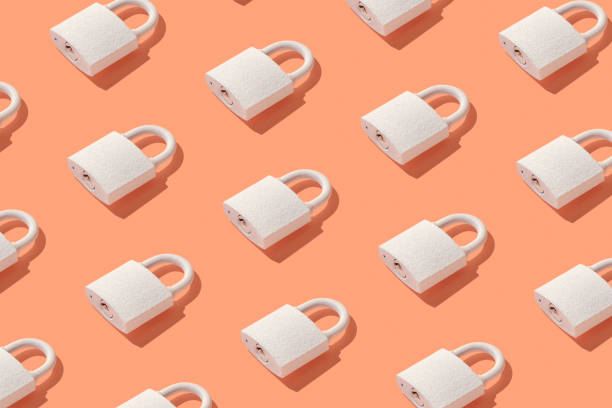 Pattern from padlock on trendy coral background. Minimal concept of protection and security. stock photo