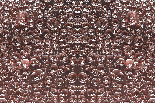 A pattern of pink-brown rings is symmetrically located on a brown background. 3D render