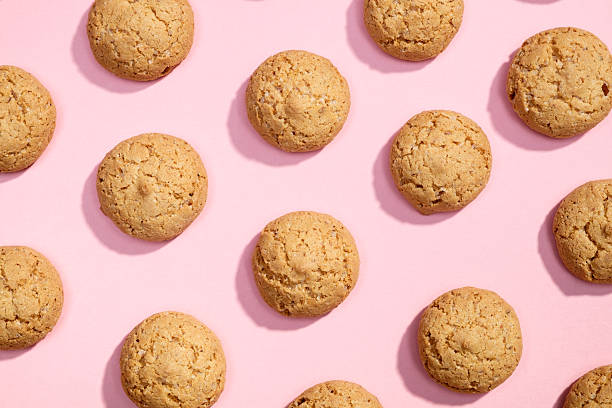 Pattern of sweet cookies on pink background stock photo