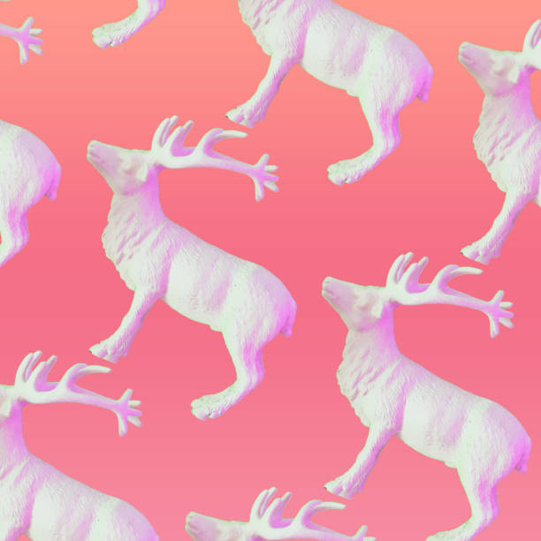 Pattern of white reindeers on pink gradient background. Christmas decorations stock photo