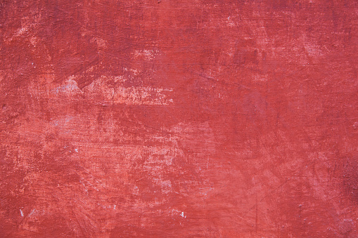 pattern on part of wall with plaster in different shades of red
