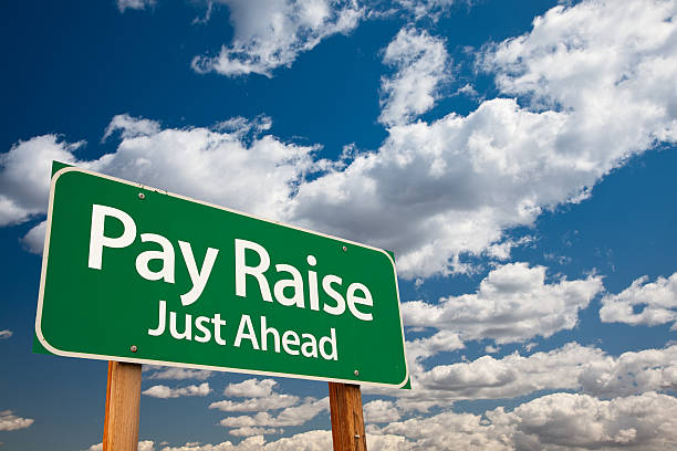 Pay Raise Green Road Sign stock photo