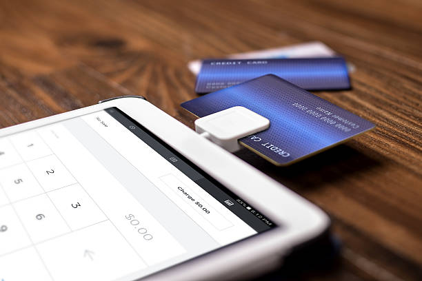 Payment with a Credit Card Chip Reader on a Tablet stock photo