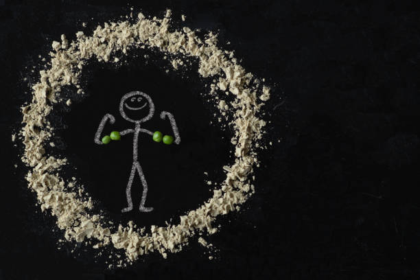 Pea protein powder stick figure A human stick figure drawn with chalk is flexing his muscles, which are made out of peas. There is a circle of pea protein powder around him. pea protein powder stock pictures, royalty-free photos & images