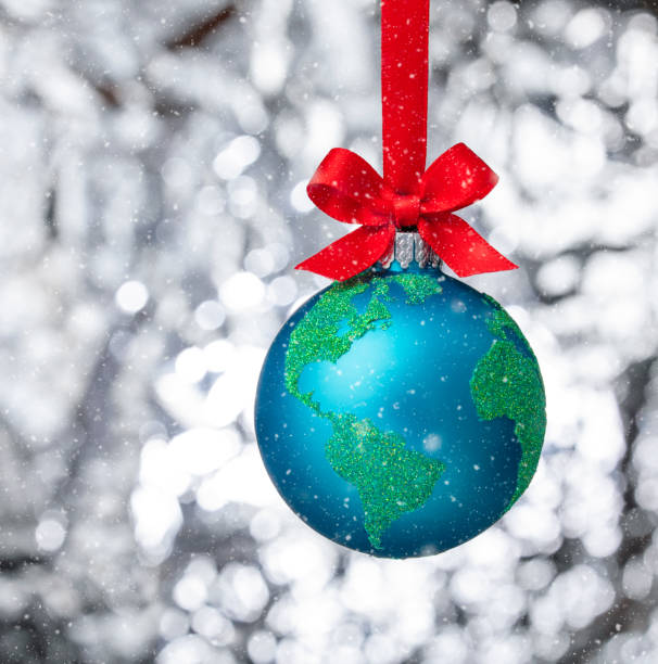 Peace on Earth Globe christmas ball ornament with snowy winter background stock photo
