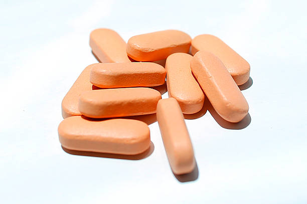 Peach colour pills on a white background stock photo