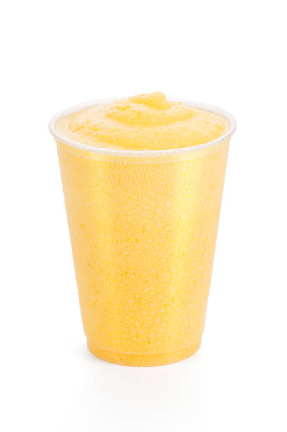 Peach or Mango Smoothie On White Background Icy cold fruit smoothie on white background - could be peach, mango or orange flavored. peach smoothie stock pictures, royalty-free photos & images