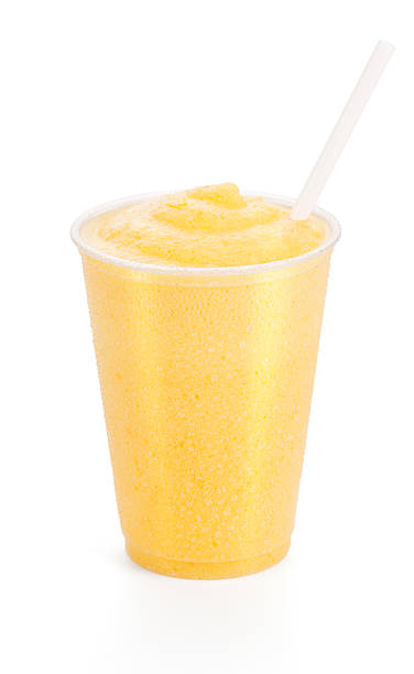 Peach or Mango Smoothie with Straw "A refreshing yellowish-orange colored smoothie on white background - could be peach, mango, orange or tangerine flavored." orange smoothie stock pictures, royalty-free photos & images
