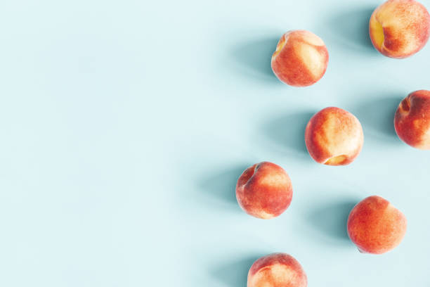 Peaches on pastel blue background. Frame made of fresh peaches. Flat lay, top view, copy space Peaches on pastel blue background. Frame made of fresh peaches. Flat lay, top view, copy space peach smoothie stock pictures, royalty-free photos & images