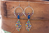 istock Peacock earrings with colorful beads 629995216