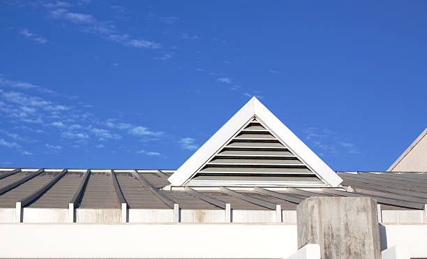 Peaked Roof Vent against a beautiful blue sky Peaked roof vent against a beautiful blue sky with small whispy clouds.  Sky color was not enhanced. gable stock pictures, royalty-free photos & images