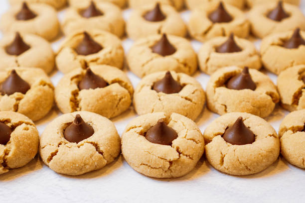 Peanut butter blossom cookies Peanut butter blossom cookies on a flat surface blossom stock pictures, royalty-free photos & images