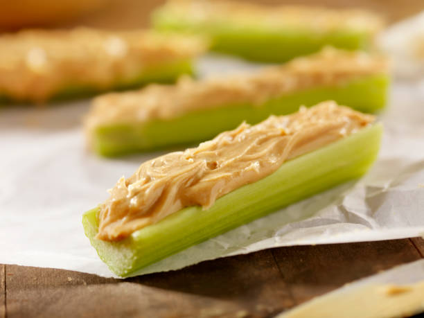 Peanut Butter on Sticks of Celery Peanut Butter on Sticks of Celery -Photographed on Hasselblad H3-22mb Camera celery stock pictures, royalty-free photos & images