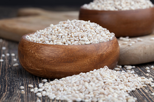 pearl barley for cooking porridge, cereals are scattered in dishes on the table, pearl barley is made from barley