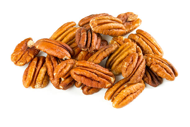 pecan nuts over white pecan nuts over white pecan stock pictures, royalty-free photos & images