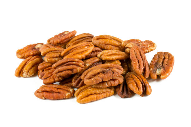 pecan nuts over white pecan nuts over white pecan stock pictures, royalty-free photos & images