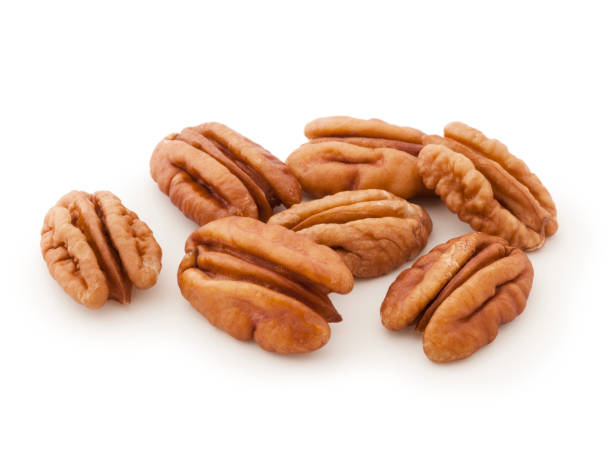Pecans on white Fresh pecans isolated on white background pecan stock pictures, royalty-free photos & images