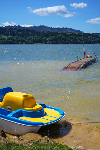 pedal boat and wooden pier on the Czorsztyn Lake in Poland