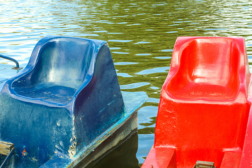 Lake sororunded \ncolorful boats to ride parked at the lake \nPalermo, Buenos Aires, argentina