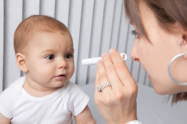 Pediatrician Checking Baby's Eyes stock photo
