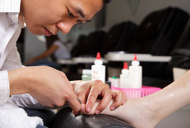 Pedicure Close Up A manicurist working in a nail salon. man pedicure stock pictures, royalty-free photos & images