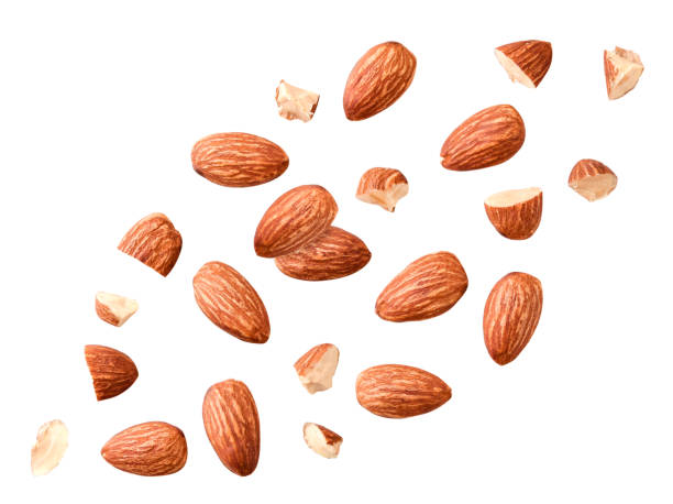 Peeled almonds whole and pieces flying on a white. Isolated Peeled almonds whole and pieces flying on a white background. Isolated almond stock pictures, royalty-free photos & images