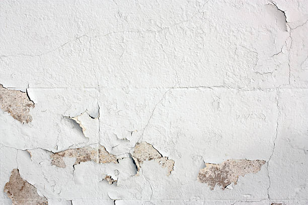 Peeling white-painted wall detail stock photo