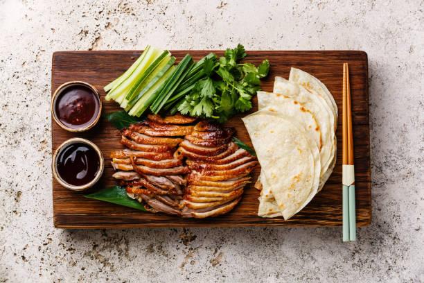 Peking Duck with cucumber, onions, cilantro and pancakes stock photo