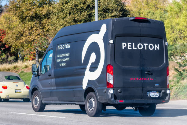 Peloton minivan driving on the freeway Dec 9, 2019 Los Angeles / USA - Peloton minivan driving on the freeway; Peloton Interactive is an American exercise equipment and media company whose main product is a luxury stationary bicycle peloton stock pictures, royalty-free photos & images