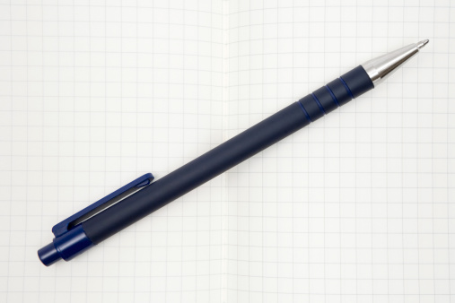 Ballpoint pen on an open notebook.