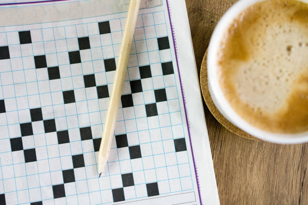 Pen on puzzle paper and coffee stock photo