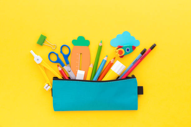 Pencil case on yellow background. Back to school concept. Pencil case with school supplies on yellow background. Back to school concept. school supplies stock pictures, royalty-free photos & images