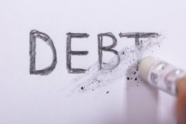 pencil eraser erasing debt word - dívidas imagens e fotografias de stock