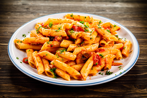 Penne with sauce and pork