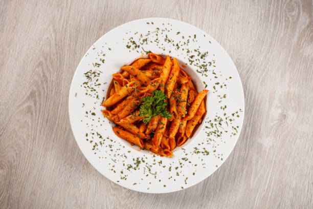 Penne with tomato sauce and pork Penne pasta in tomato sauce with meat, tomatoes macaroni stock pictures, royalty-free photos & images