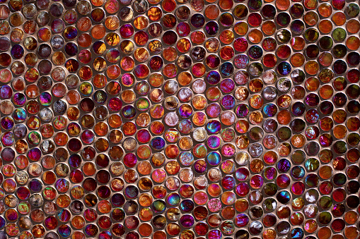Penny round mosaic tiles. Round circle tile. Glass abstract round multicolor mosaic pattern. Mosaic background of round glass balls in wall. Colored mosaic square for background texture.